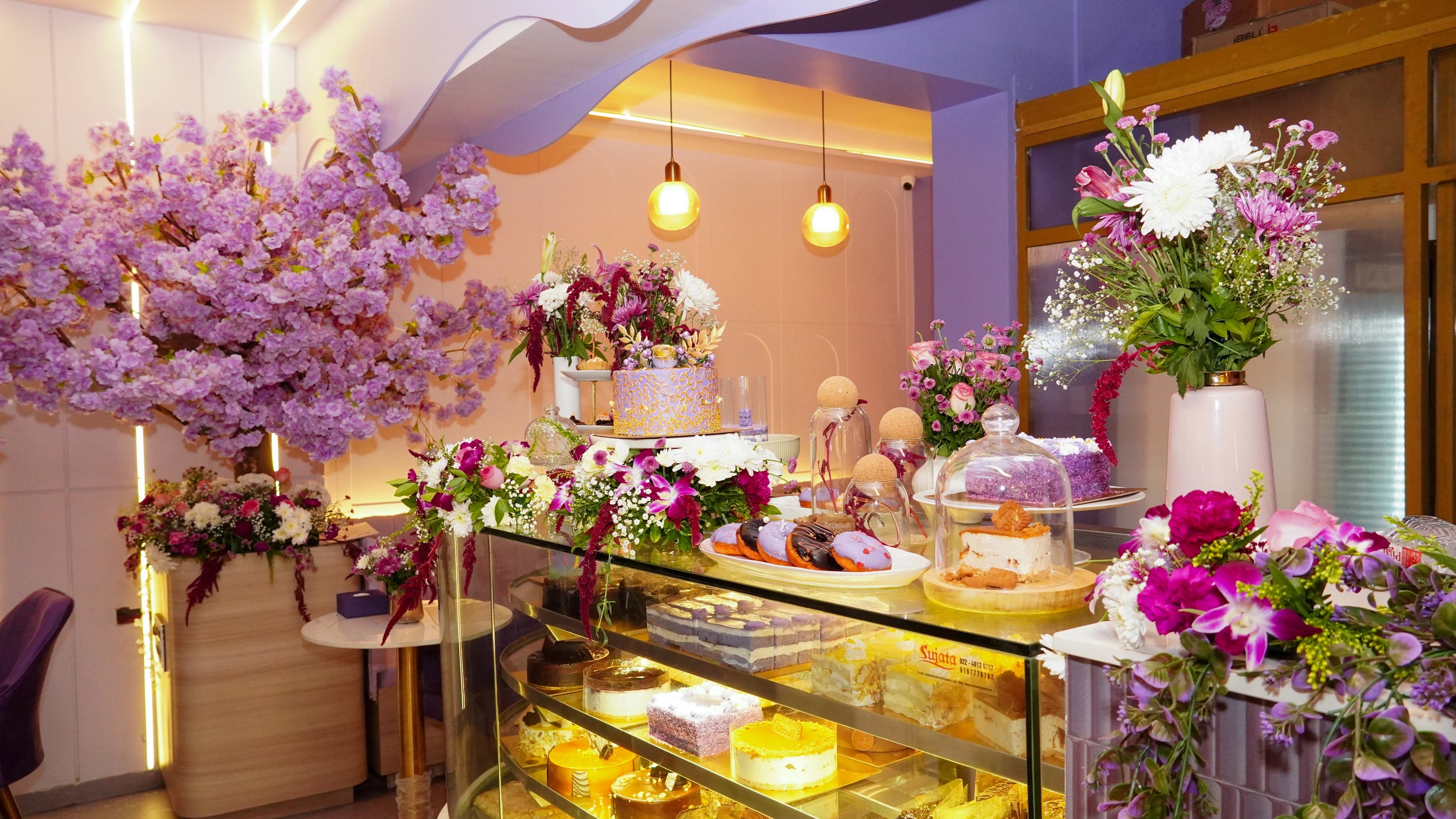 Decorative floral arrangements in a store setting with a focus on purple and pink flowers.