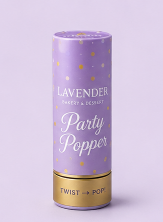 A product lineup graphic showing lavender and silver party accessories on a light lavender background, including a gold and lavender crown, lavender snow spray cans, a silver tiara, a lavender party popper, a lavender spiral candle, and two silver sparkles.