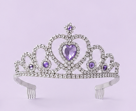 A product lineup graphic showing lavender and silver party accessories on a light lavender background, including a gold and lavender crown, lavender snow spray cans, a silver tiara, a lavender party popper, a lavender spiral candle, and two silver sparkles.
