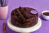 Dutch Truffle Cake with moist chocolate sponge, rich chocolate frosting, and decorative truffle cream swirls.