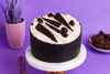 Black Forest Cake with moist chocolate sponge, whipped cream, cherries, chocolate curls, and elegant chocolate decorations.