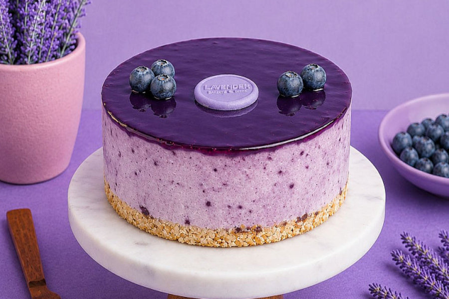 Blueberry Cheesecake with a buttery biscuit base, creamy blueberry filling, glossy blueberry topping, and fresh blueberry decoration.